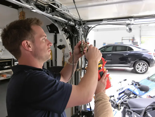 Central Falls Garage Door Repair safety certified technician performing cable replacement in Central Falls